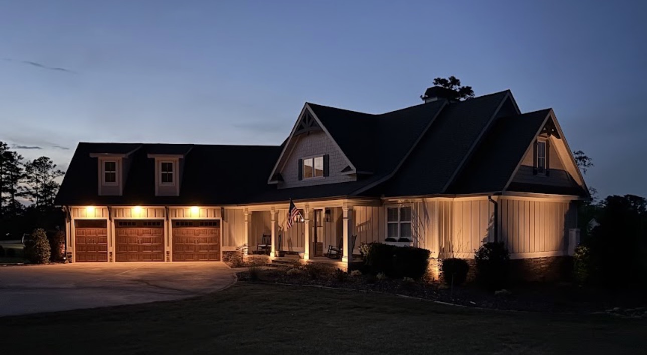 Accent lighting along a three-car garage and porch