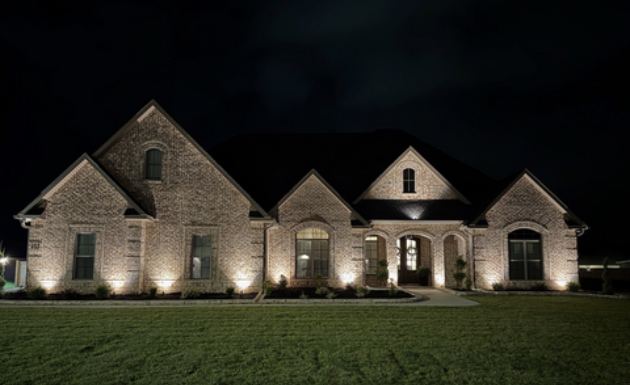 Accent lighting on a stone and brick home exterior